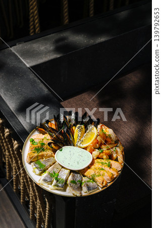 Seafood platter served on a table with sauce and garnishes for sharing 139792653
