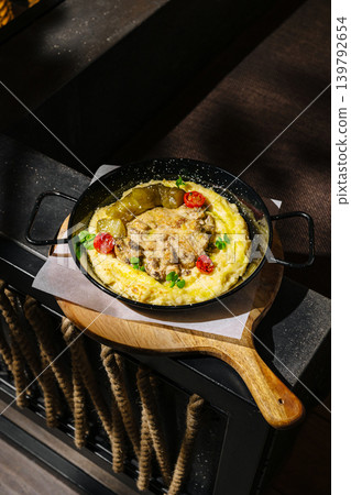 Delicious dish with chicken served on wooden board in restaurant Delicious dish with chicken served on wooden board in restaurant 139792654