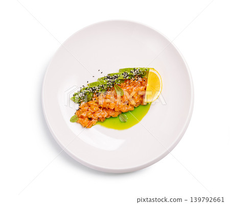 Salmon tartare with avocado and lemon on a white plate with fresh ingredients and sauce Salmon tartare with avocado and lemon on a white plate with fresh ingredients and sauce 139792661