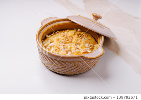 Delicious dessert prepared in a clay pot on a kitchen counter 139792671