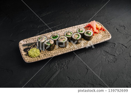 Sushi on a plate with wasabi and ginger at a restaurant Sushi on a plate with wasabi and ginger at a restaurant 139792699