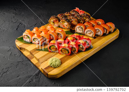 Sushi rolls on wooden board with wasabi and ginger at restaurant 139792702