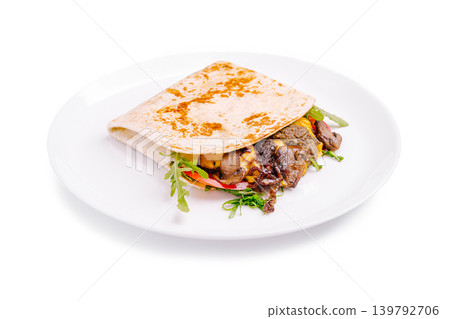 Tasty wrap with grilled meat and fresh vegetables on a white plate 139792706