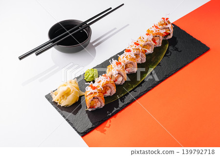 Sushi rolls arranged on a plate with wasabi and ginger in a restaurant setting Sushi rolls arranged on a plate with wasabi and ginger in a restaurant setting 139792718