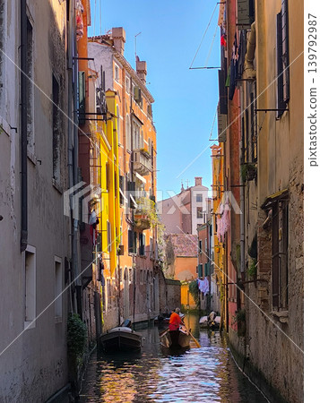 A morning scene in Venice: Residents rowing boats on a small canal. A morning scene in Venice: Residents rowing boats on a small canal. 139792987