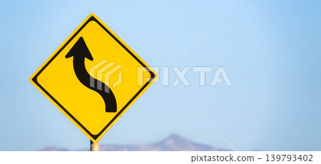 An imagined scene with a sign indicating a series of curves ahead. An imagined scene with a sign indicating a series of curves ahead. 139793402