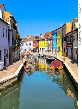 A landscape along the canal lined with colorful houses on Burano Island. A landscape along the canal lined with colorful houses on Burano Island. 139793714