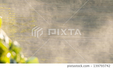The surface of the water, shrouded in morning mist, at Togo Pond. The surface of the water, shrouded in morning mist, at Togo Pond. 139793742