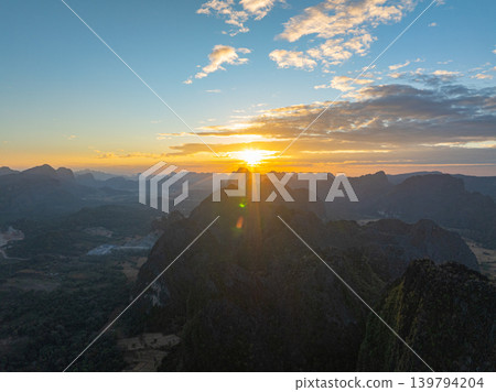 Aerial Over Majestic Mountains Beneath a Colorful Sky Aerial Over Majestic Mountains Beneath a Colorful Sky 139794204