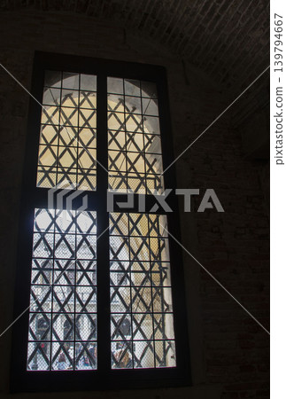 Interior view of a Venetian building: a decorative window with a lattice. Interior view of a Venetian building: a decorative window with a lattice. 139794667