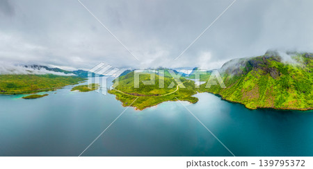 Aerial drone view of a winding road in Lofoten islands, Norway. Foggy arctic landscape. 139795372