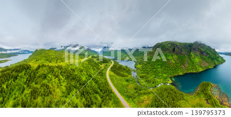 Aerial drone view of a winding road in Lofoten islands, Norway. Foggy arctic landscape. Aerial drone view of a winding road in Lofoten islands, Norway. Foggy arctic landscape. 139795373
