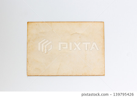 Blank aged paper on white background, top view. Vintage yellowed paper texture flat lay, old antique document background with copy space. Blank aged paper on white background, top view. Vintage yellowed paper texture flat lay, old antique document background with copy space. 139795426