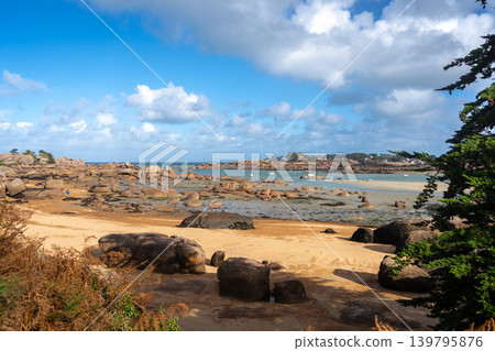 Granite chaos landscape facing Mean Ruz lighthouse in Tregastel, France Granite chaos landscape facing Mean Ruz lighthouse in Tregastel, France 139795876