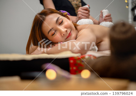 Woman relaxes during a serene spa massage Woman relaxes during a serene spa massage 139796024