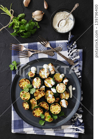 fried zucchini with garlic yogurt sauce on plate fried zucchini with garlic yogurt sauce on plate 139796400
