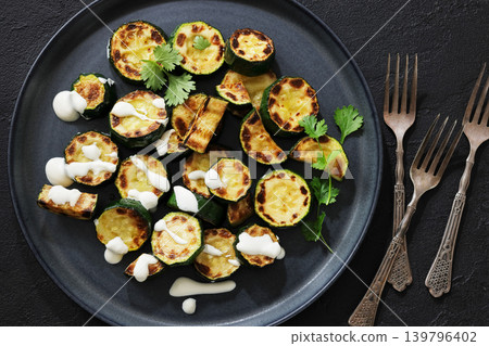 fried zucchini with garlic yogurt sauce on plate fried zucchini with garlic yogurt sauce on plate 139796402