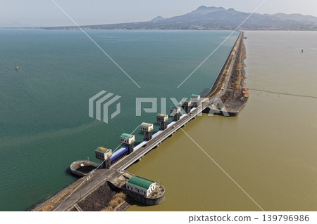 Aerial photograph of the Isahaya Bay reclamation embankment road and tidal barrier gate in Nagasaki Prefecture. Aerial photograph of the Isahaya Bay reclamation embankment road and tidal barrier gate in Nagasaki Prefecture. 139796986