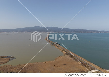 An aerial photograph overlooking the Isahaya Bay reclamation embankment road in Nagasaki Prefecture and the Ariake Sea. An aerial photograph overlooking the Isahaya Bay reclamation embankment road in Nagasaki Prefecture and the Ariake Sea. 139796987