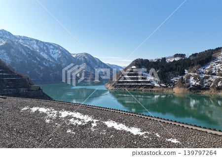 A winter aerial photograph overlooking the Tedori Lake Dam and its emerald-green reservoir in Hakusan City, Ishikawa Prefecture. A winter aerial photograph overlooking the Tedori Lake Dam and its emerald-green reservoir in Hakusan City, Ishikawa Prefecture. 139797264