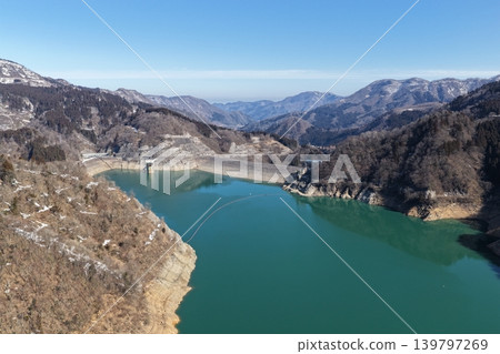 A winter aerial photograph overlooking the rock-fill dam at Lake Tedori in Hakusan City, Ishikawa Prefecture. A winter aerial photograph overlooking the rock-fill dam at Lake Tedori in Hakusan City, Ishikawa Prefecture. 139797269