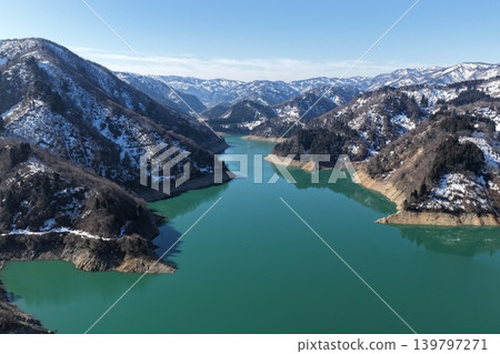 A winter aerial photograph of Lake Tedori in Ishikawa Prefecture, with snow-capped mountains in the background. A winter aerial photograph of Lake Tedori in Ishikawa Prefecture, with snow-capped mountains in the background. 139797271