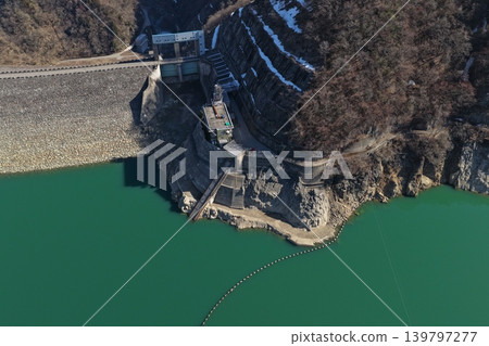 An aerial photograph showing the dam facilities at Lake Tedori in Hakusan City, Ishikawa Prefecture, viewed from an oblique angle. An aerial photograph showing the dam facilities at Lake Tedori in Hakusan City, Ishikawa Prefecture, viewed from an oblique angle. 139797277