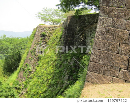 The stone walls of Oka Castle Ruins, a nationally designated historical site and one of Japan's 100 Famous Castles, located in Taketa City, Oita Prefecture, known for Rentaro Taki's song "Kojo no Tsuki" (The Moon over the Ruined Castle). The stone walls of Oka Castle Ruins, a nationally designated historical site and one of Japan's 100 Famous Castles, located in Taketa City, Oita Prefecture, known for Rentaro Taki's song "Kojo no Tsuki" (The Moon over the Ruined Castle). 139797322