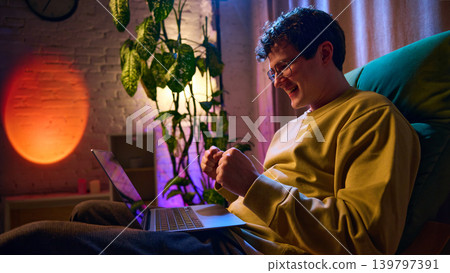 Man browsing products on laptop at home comparing offers ecommerce shopping process 139797391