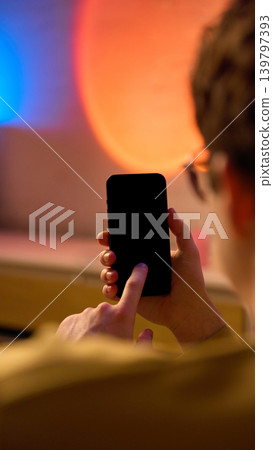 Close up hands using smartphone at home warm light mobile ecommerce online shopping Close up hands using smartphone at home warm light mobile ecommerce online shopping 139797393