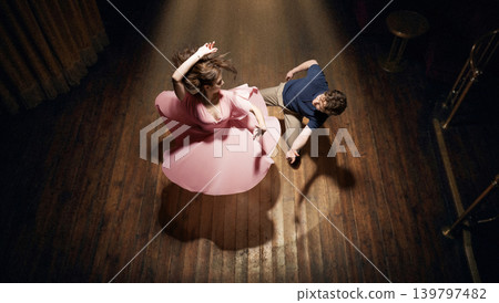 Lindy hop dance couple spinning on wooden floor top view dynamic motion vintage lifestyle energy Lindy hop dance couple spinning on wooden floor top view dynamic motion vintage lifestyle energy 139797482