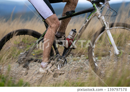 Close-up racer feet and mountain bike Close-up racer feet and mountain bike 139797578