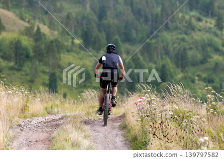 Participant in mountain bike race Participant in mountain bike race 139797582