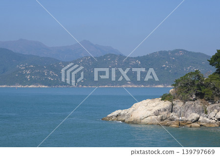 Lantau Island as seen from a hiking trail on Cheung Chau Island Lantau Island as seen from a hiking trail on Cheung Chau Island 139797669