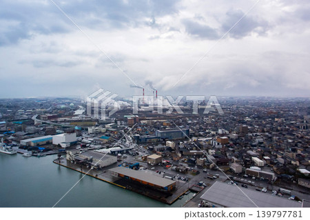 An aerial view of Niigata Port and its industrial area under a cloudy sky. 139797781