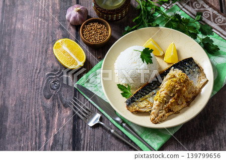 Grilled baked mackerel in a ginger mustard honey sauce, served with rice on a rustic table. Copy space. Grilled baked mackerel in a ginger mustard honey sauce, served with rice on a rustic table. Copy space. 139799656