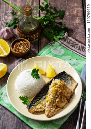 Grilled baked mackerel in a ginger mustard honey sauce, served with rice on a rustic table. 139799659