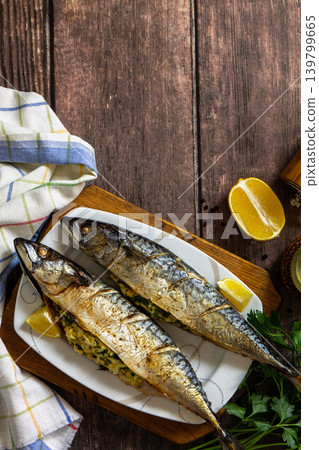 Grilled baked mackerel in ginger mustard honey sauce stuffed with vegetables and cheese on a rustic tabletop. View from above. Copy space. 139799665