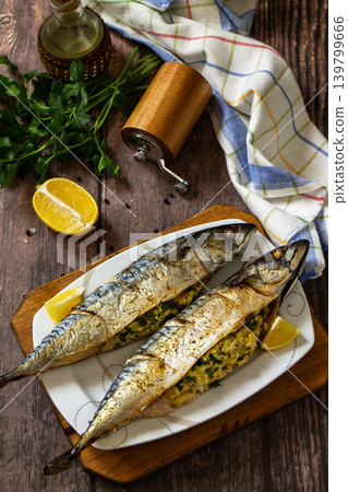 Grilled baked mackerel in ginger mustard honey sauce stuffed with vegetables and cheese on a rustic tabletop. 139799666
