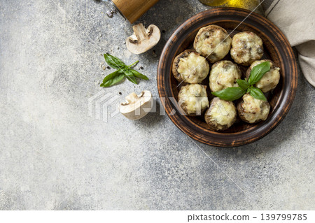 Keto stuffed mushrooms baked with cheese on a stone tabletop. View from above. Copy space. 139799785