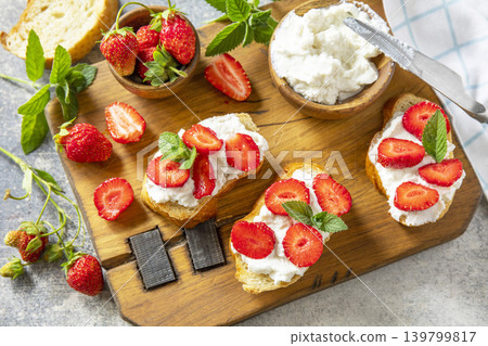 Bruschetta with ricotta and strawberry on a stone tabletop. Berries toast summer breakfast, healthy food. 139799817