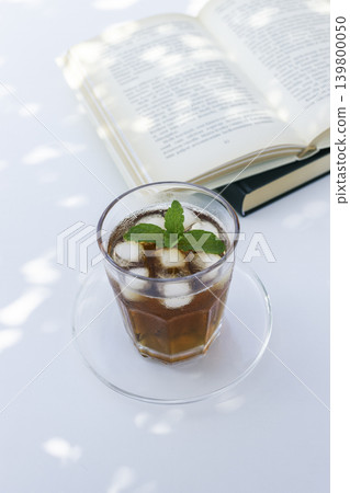 Reading and iced tea: A relaxing summer time. Reading and iced tea: A relaxing summer time. 139800050