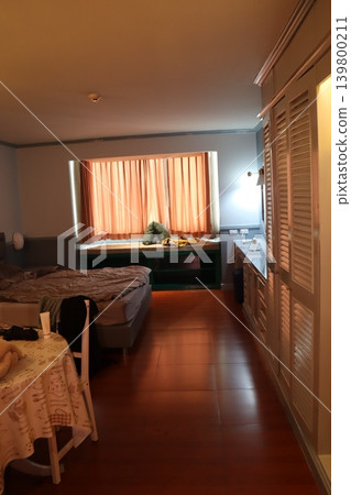 Cozy Bedroom with Wooden Floor and Window 139800211