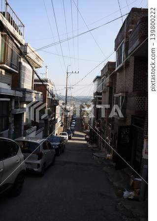 Urban Alley with Residential Buildings and Vehicles 139800222