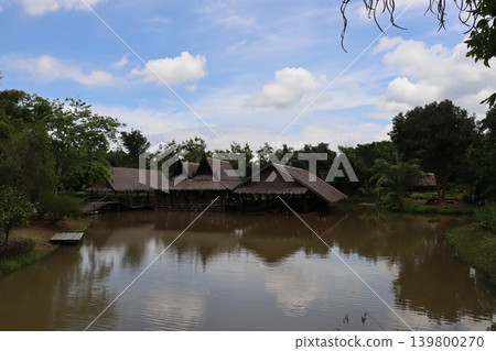 Traditional Stilt Houses Over Water in Tropical Landscape Traditional Stilt Houses Over Water in Tropical Landscape 139800270