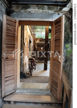 Wooden Shutter Opening to Traditional Workshop Courtyard Wooden Shutter Opening to Traditional Workshop Courtyard 139800421