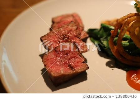 Grilled Steak Slices with Salad and Onion Rings Grilled Steak Slices with Salad and Onion Rings 139800436