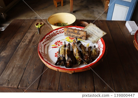 Traditional Thai Wrapped Food on Wooden Table Traditional Thai Wrapped Food on Wooden Table 139800447