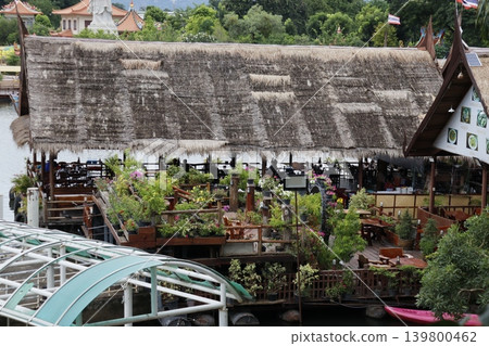 Thatched Roof Waterfront Restaurant with Lush Greenery Thatched Roof Waterfront Restaurant with Lush Greenery 139800462