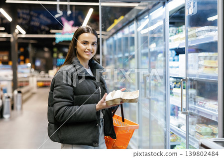 Woman shopping for eggs choosing products in supermarket Woman shopping for eggs choosing products in supermarket 139802484